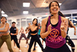a group shot of many eos gym goes participating in a zumba class