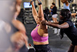 personal trainer helping eos member on lat pulldown cable machine