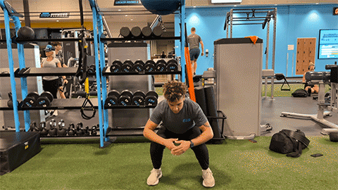 eos member performing a jump squat