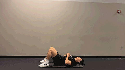 eos member performing a glute bridge