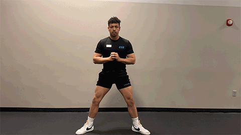 eos member performing a bodyweight squat